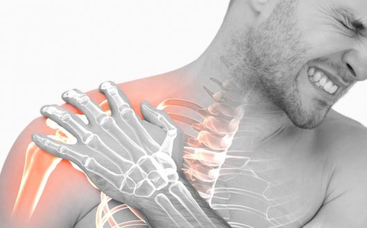 Man in pain holding right shoulder. Partially looks x-rayed and red where the pain is present.